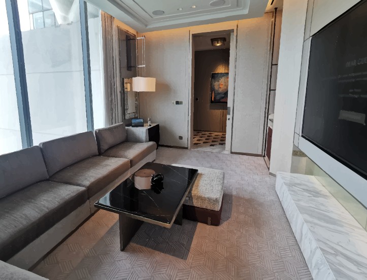 Paiza suite with dark cinema screen and sectional sofa